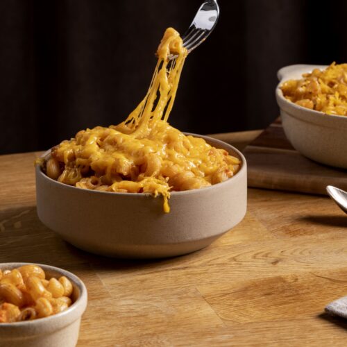 Close-up of creamy smoked mac and cheese in a cast-iron skillet, topped with golden breadcrumbs.